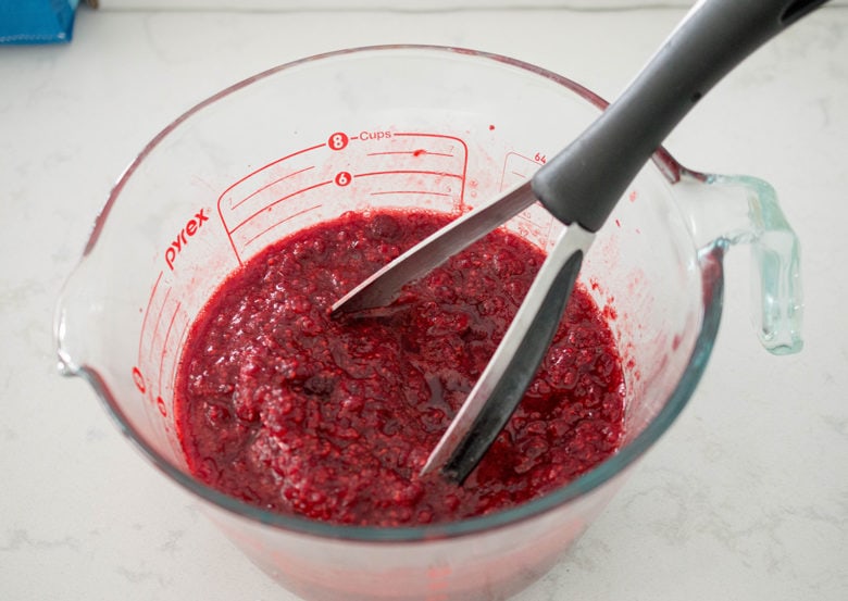 Crushed raspberries for homemade low sugar raspberry jam.