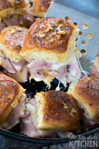 Cast Iron Baked Ham and Swiss Sliders via This Silly Girl's Kitchen