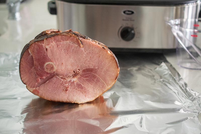 maple glazed ham on a sheet of alumim foil before roasting