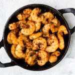 blackened keto shrimps in a cast-iron skillet