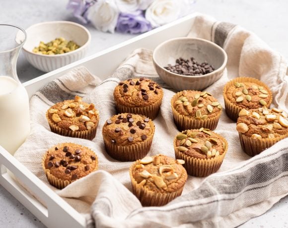 tray of almond flour muffins with chocolate chips and nuts