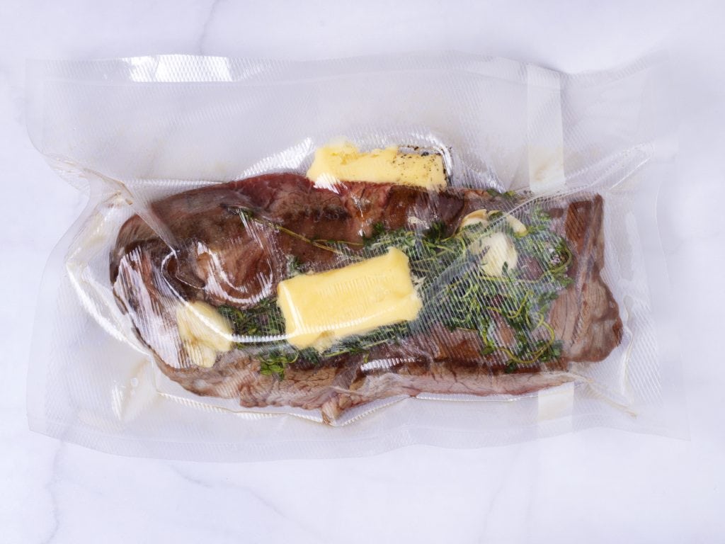 vacume sealed bag wtih chuck roast, butter and aromatics