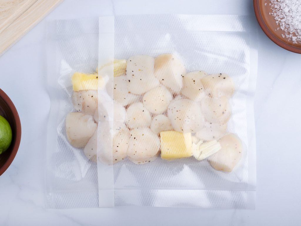 raw scallops in a vacuum sealed bag with garlic and butter